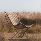 Contemporary Scandinavian Handwoven Rattan Lounge Chair - Accent Chair With Ergonomic Backrest & Iron Base For Boutique Indoor & Outdoor Spaces Lumendat